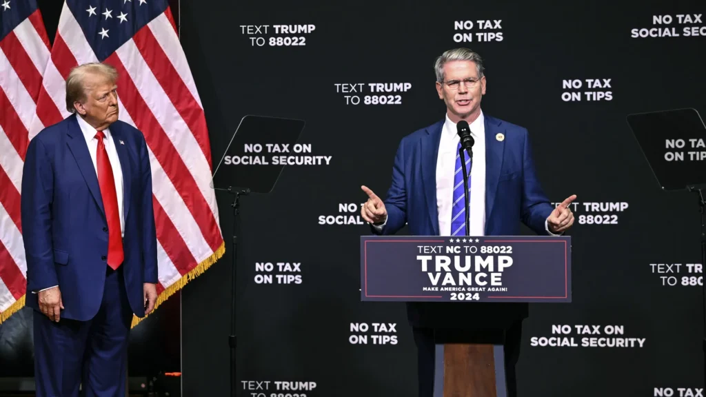 Republican presidential nominee former President Donald Trump, left, listens as investor Scott Bessent speaks on the economy in Asheville, N.C., Wednesday, Aug. 14, 2024 (AP Photo/Matt Kelley)